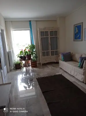 a living room with a couch and a window at Stamatis Big Apartment in Spáta