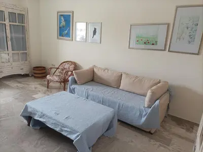 a living room with a couch and a table at Stamatis Big Apartment in Spáta