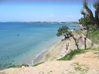 a group of people on a beach near the water at SEASIDE SUNSET WALKS in Athens