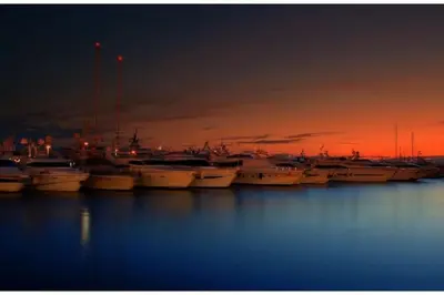 a group of boats docked in a harbor at sunset at SEASIDE SUNSET WALKS in Athens