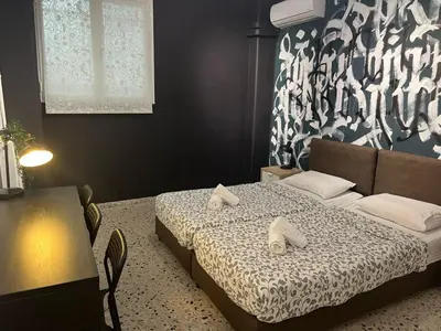 a bedroom with a bed with two towels on it at Cyber Loft - Futuristic Athens VIPGreece in Athens