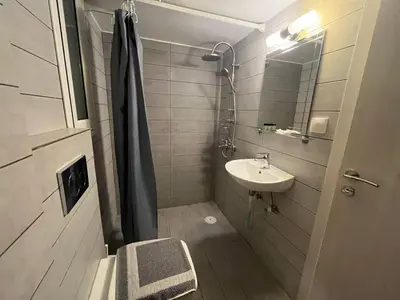 a small bathroom with a sink and a shower at Cyber Loft - Futuristic Athens VIPGreece in Athens
