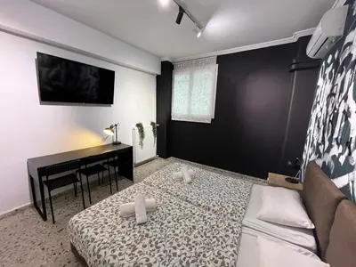a bedroom with a bed and a desk and a piano at Cyber Loft - Futuristic Athens VIPGreece in Athens