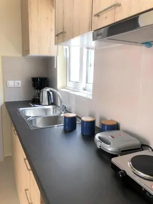 a kitchen with a sink and a counter top at Bohem Apartment near Athens Airport in Spáta
