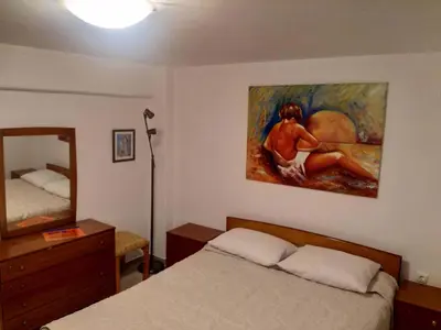 a bedroom with a bed and a painting on the wall at Art apartment Syngrou in Athens