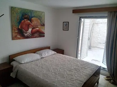 a bedroom with a bed and a painting on the wall at Art apartment Syngrou in Athens