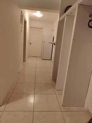 a hallway with white walls and a tile floor at Art apartment Syngrou in Athens