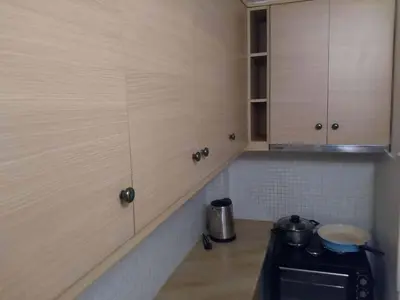 a kitchen with wooden cabinets and a stove at Art apartment Syngrou in Athens