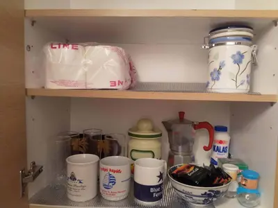 a shelf with cups and other items on it at Art apartment Syngrou in Athens