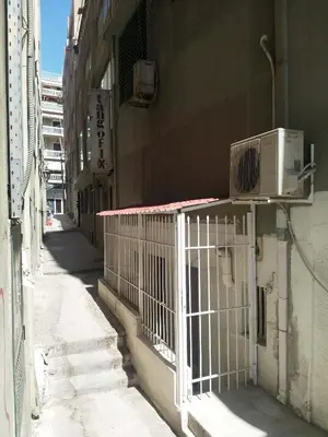 a white gate on the side of a building at Art apartment Syngrou in Athens