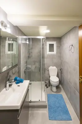 a bathroom with a shower and a toilet and a sink at Athens Kyniska Urban Apartment in Athens