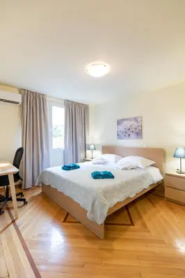 a bedroom with a large bed with two towels on it at Athens Kyniska Urban Apartment in Athens