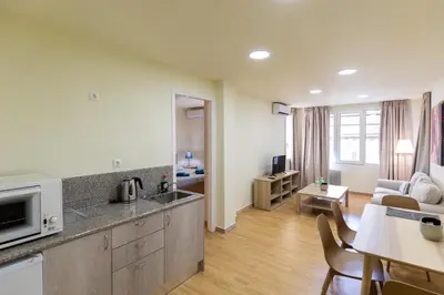 a kitchen and living room with a couch and a table at Athens Kyniska Urban Apartment in Athens