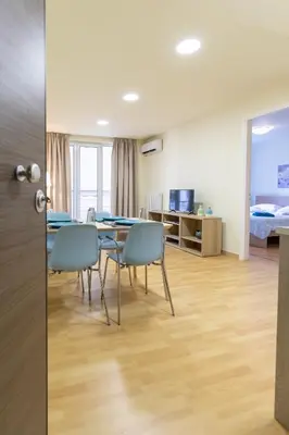 a room with a table and chairs and a bedroom at Athens Kyniska Urban Apartment in Athens