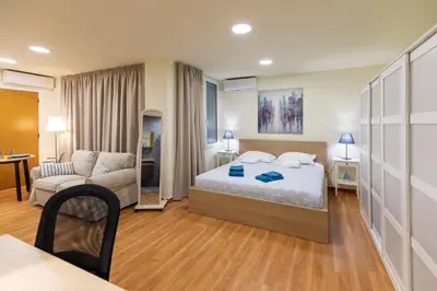 a hotel room with a bed and a couch at Athens Kyniska Studio in Athens