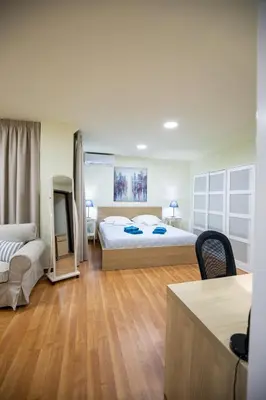 a large bedroom with a bed and a couch and a table at Athens Kyniska Studio in Athens