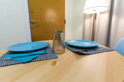 a table with two blue plates and a glass at Athens Kyniska Studio in Athens
