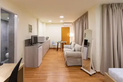 a living room with a couch and a television in a room at Athens Kyniska Studio in Athens