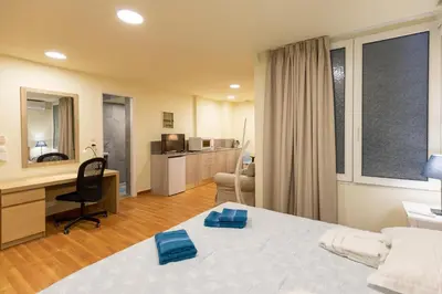 a bedroom with a bed and a desk with a computer at Athens Kyniska Studio in Athens