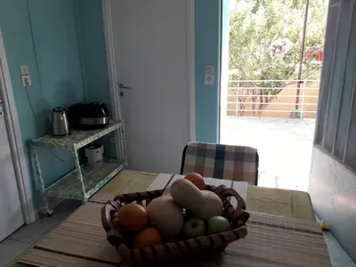 a basket of fruit on a table in a kitchen at Painter's house by the beach in Athens