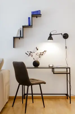 a desk with a chair and a lamp at Modern 1BD Apartment close to the Acropolis Museum by UPSTREET in Athens