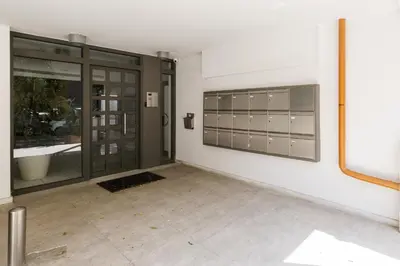 an empty room with a wall with glass doors at Modern 1BD Apartment close to the Acropolis Museum by UPSTREET in Athens