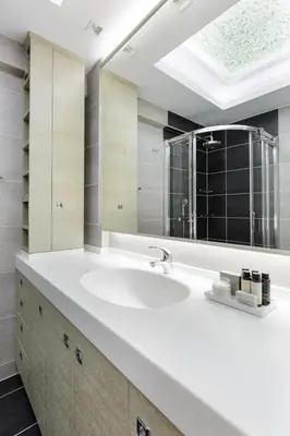 a bathroom with a white sink and a mirror at Modern 1BD Apartment close to the Acropolis Museum by UPSTREET in Athens