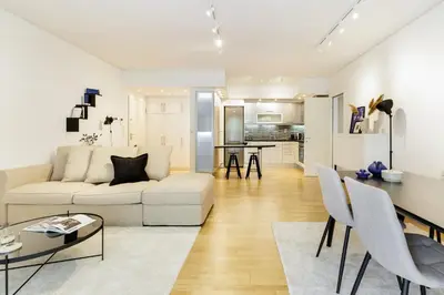 a living room with a white couch and a table at Modern 1BD Apartment close to the Acropolis Museum by UPSTREET in Athens