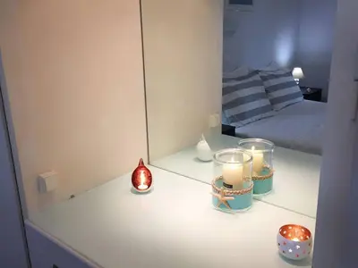 a room with a mirror and candles on a counter at A2 Cute Vouliagmeni Apt in a Unique Spot in Athens