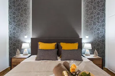 a bedroom with a large bed with yellow pillows at Cozy, Central, Safe Double rooms in apartment, close to Acropolis in Athens
