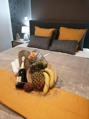 a tray of fruit and a bottle of champagne on a bed at Cozy, Central, Safe Double rooms in apartment, close to Acropolis in Athens