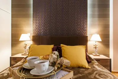 a bedroom with a bed with two cups and two lamps at Cozy, Central, Safe Double rooms in apartment, close to Acropolis in Athens