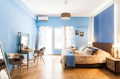 a bedroom with blue walls and a bed and a desk at Cozy, Central, Safe Double rooms in apartment, close to Acropolis in Athens