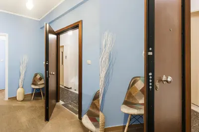 a hallway with blue walls and a door with a mirror at Cozy, Central, Safe Double rooms in apartment, close to Acropolis in Athens