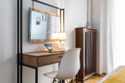 a bedroom with a desk with a chair and a mirror at Cozy, Central, Safe Double rooms in apartment, close to Acropolis in Athens