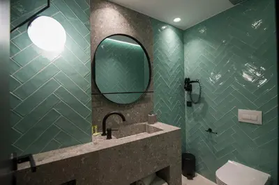 a bathroom with a sink and a mirror at Ederlezi Zoubourlou Aparthotel in Athens