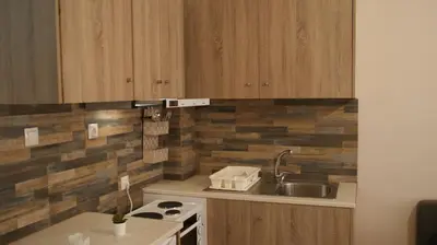 a kitchen with wooden cabinets and a sink at The Victoria Square Exceptional Apartments in Athens