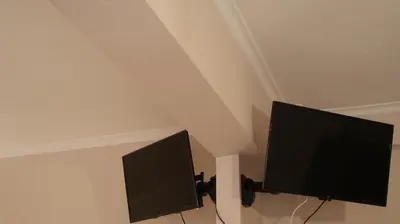 two computer monitors in a room with a ceiling at The Victoria Square Exceptional Apartments in Athens