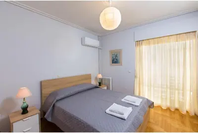 a bedroom with a bed with two towels on it at Christina's flat in Athens