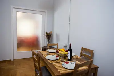 a table with a bottle of wine and a bowl of fruit at Christina's flat in Athens