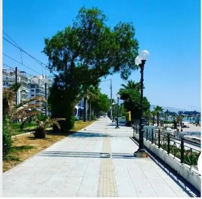 a sidewalk with a tree and a street light at Christina's flat in Athens