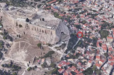 an aerial view of a city with a castle at In the shadow of Acropolis in Athens