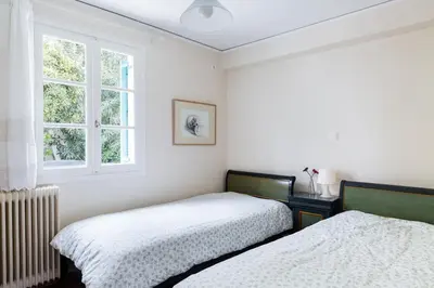 a bedroom with two beds and a window at In the shadow of Acropolis in Athens