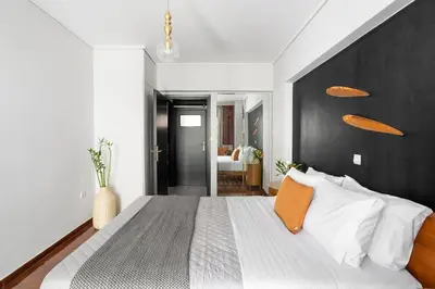 a bedroom with a large bed with a black headboard at Fresh Detailed Stylish Apartment at Acropolis in Athens