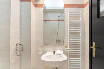 a bathroom with a sink and a shower with a ladder at Fresh Detailed Stylish Apartment at Acropolis in Athens