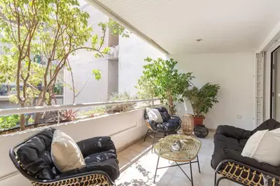 a living room with chairs and a table on a balcony at Fresh Detailed Stylish Apartment at Acropolis in Athens
