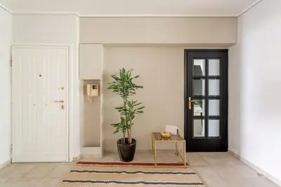 a hallway with a door and a potted plant at Fresh Detailed Stylish Apartment at Acropolis in Athens