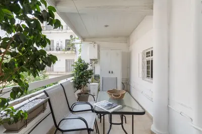 an apartment with a balcony with a table and chairs at Fresh Detailed Stylish Apartment at Acropolis in Athens