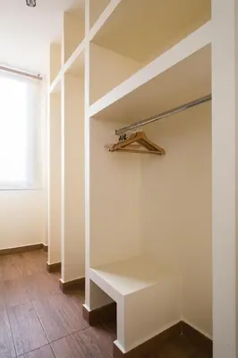 a walk in closet with white shelves and a window at Syntegma studio next to Ermou street in Athens