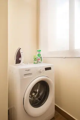 a washing machine in a room with a window at Syntegma studio next to Ermou street in Athens